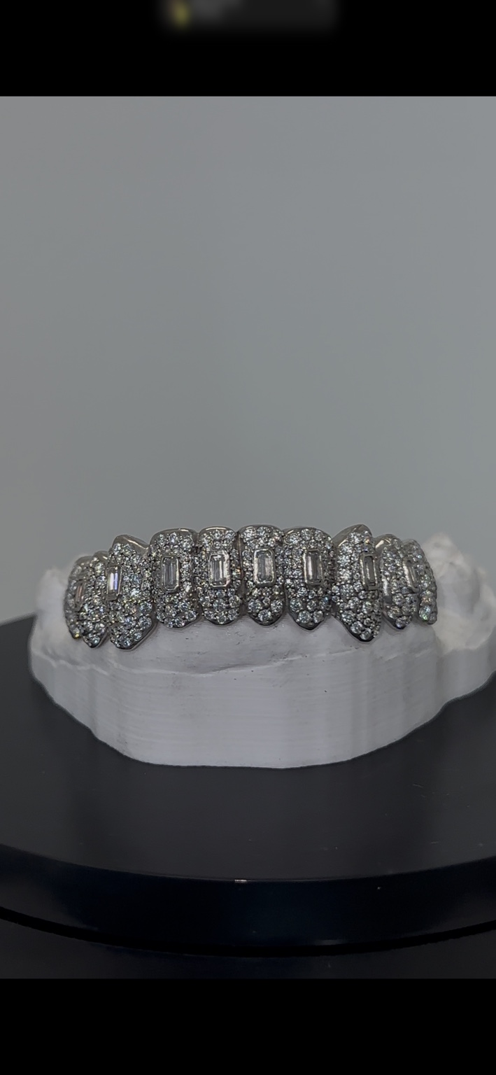 Front view of iced grillz with baguette center stones