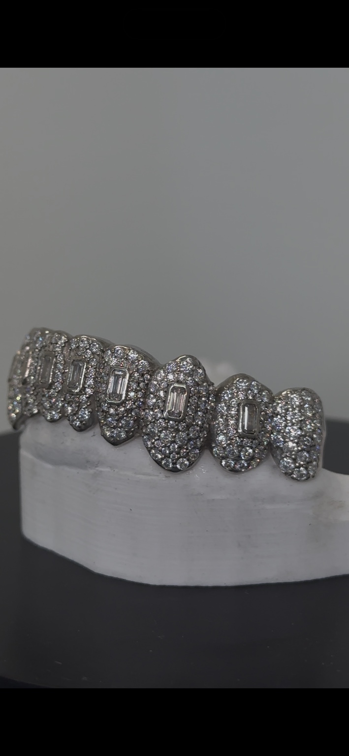 Side view of iced grillz with baguette center stones