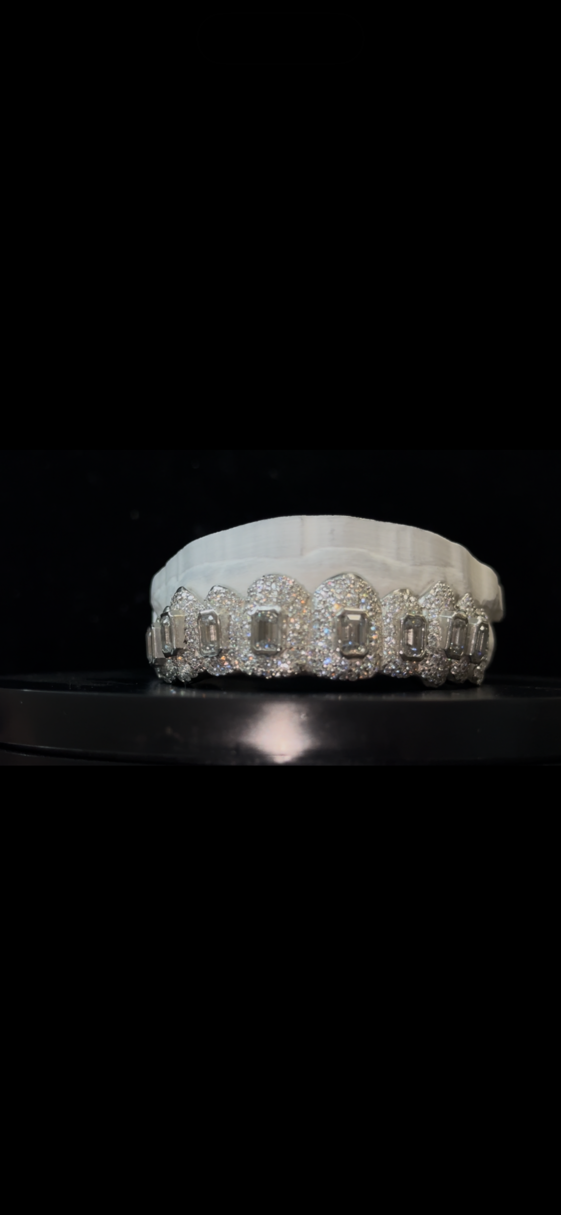 Fully iced custom grillz with emerald-cut center stones made by YZ Jewelers