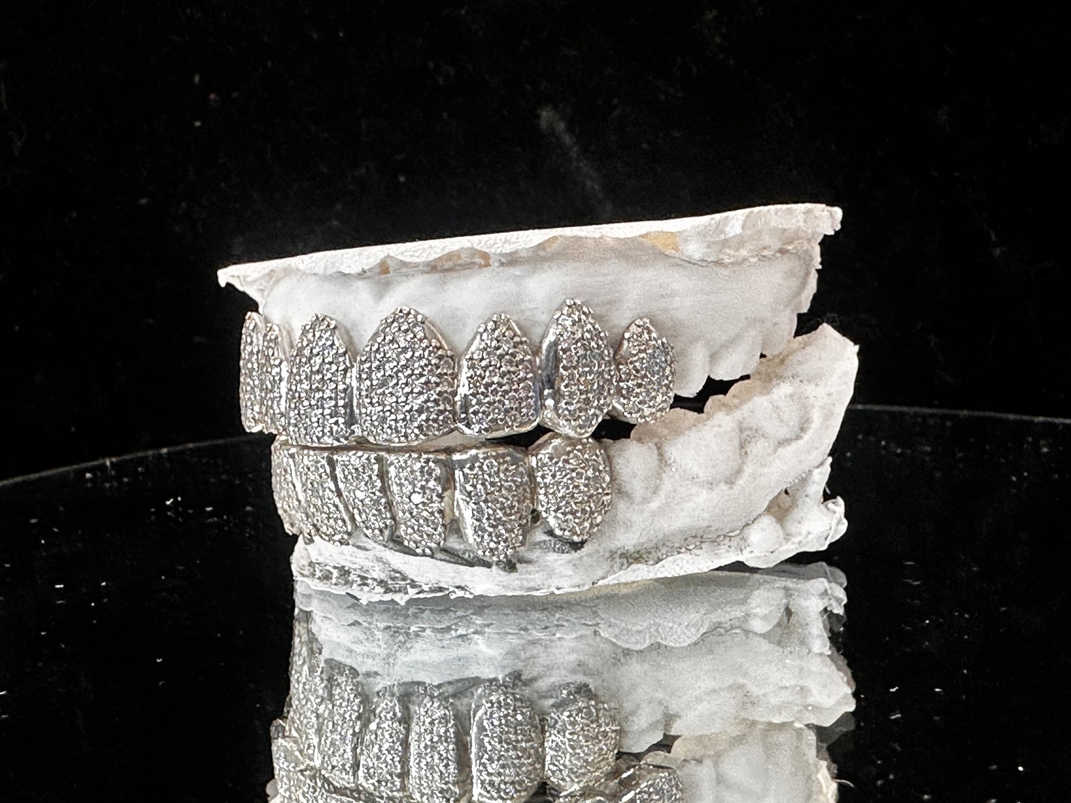 Right angle view of fully iced top and bottom grillz