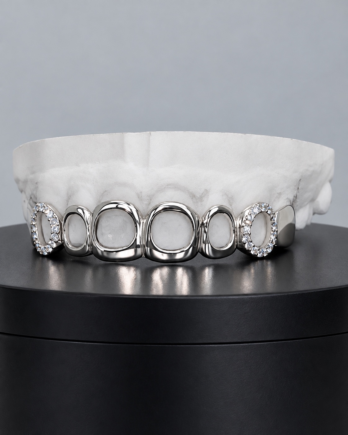 Open-face silver top grillz with iced outer teeth made by YZ Jewelers